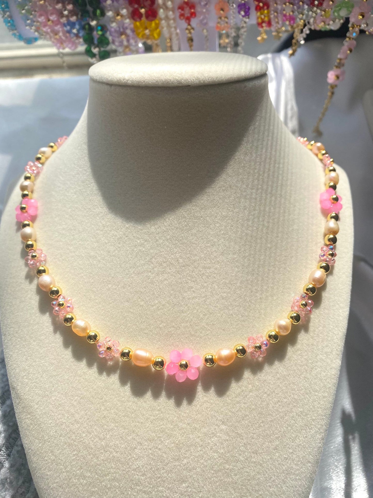 Handmade Pretty pink flower crystal beaded necklace with pink/orange freshwater pearls and 18k gold beads with a tarnish resistant gold brass chain. Crystal flowers in different sizes and different shades of pink. Perfect gift for any occasion!