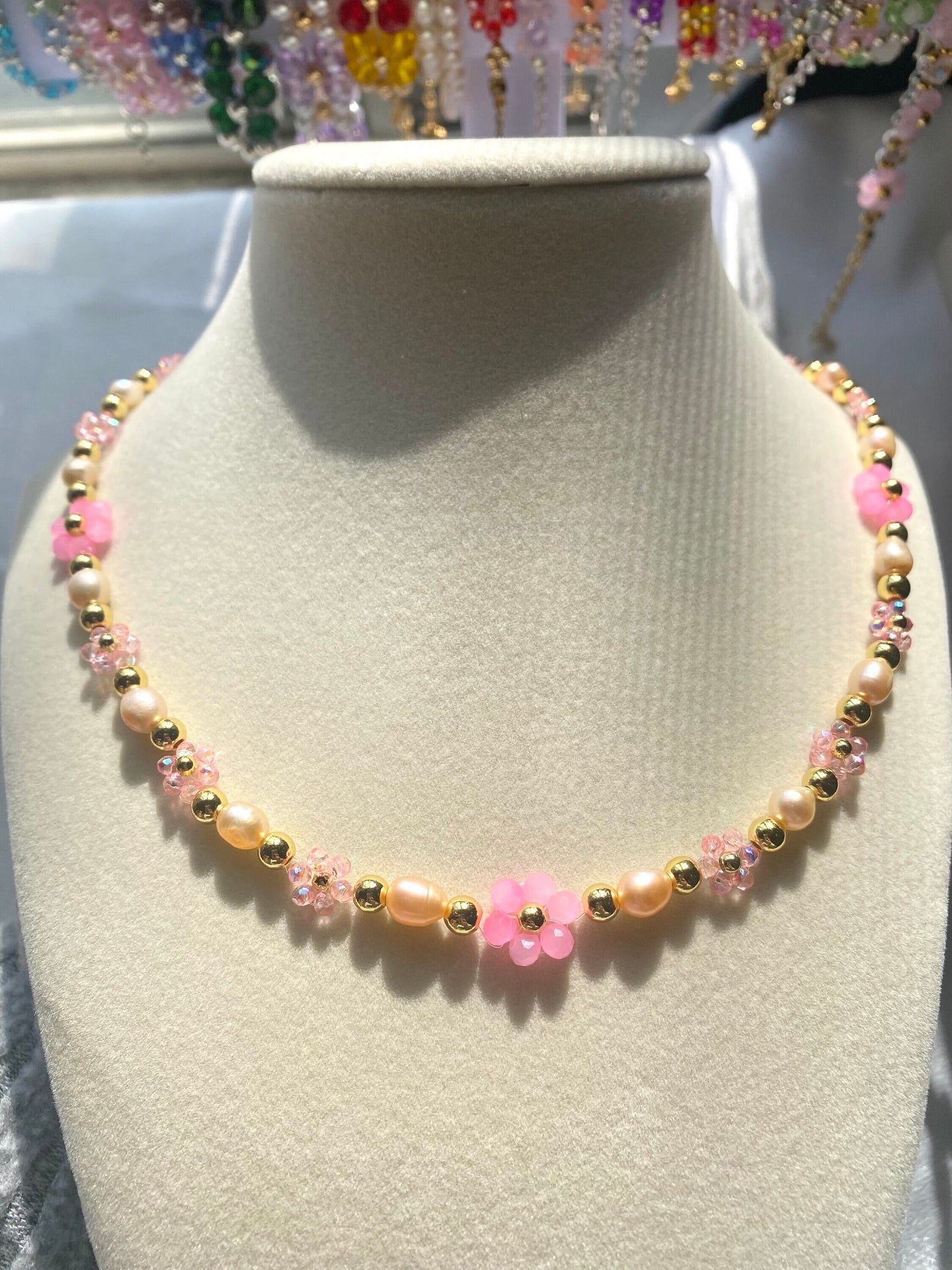 Handmade Pretty pink flower crystal beaded necklace with pink/orange freshwater pearls and 18k gold beads with a tarnish resistant gold brass chain. Crystal flowers in different sizes and different shades of pink. Perfect gift for any occasion!
