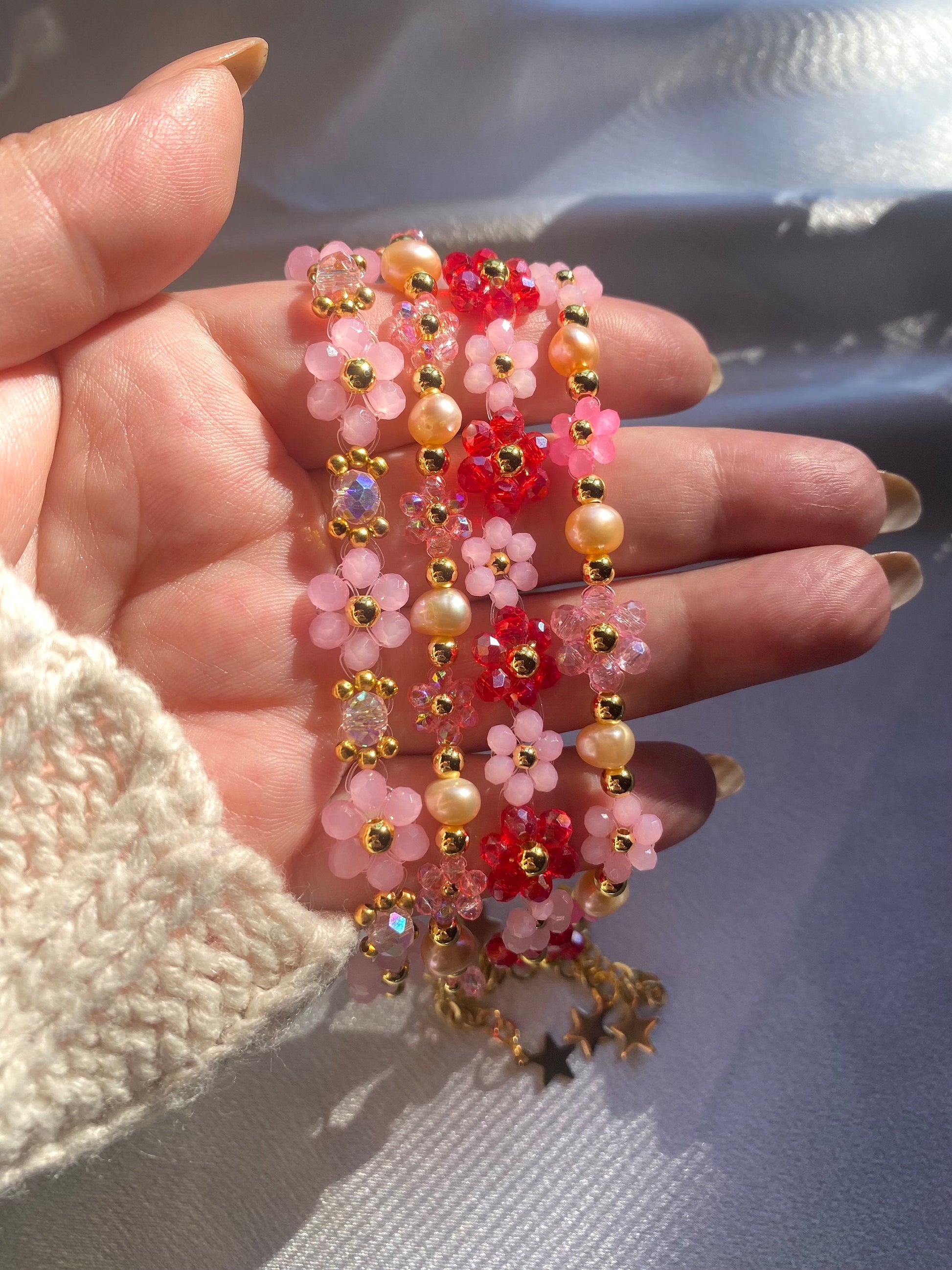 Pretty pink valentine flower crystal beaded bracelet with pink/orange pearls and 18k gold beads. Crystal flowers are a shiny pink. Perfect gift for all occasions; christmas, valentines, birthdays, mothers day