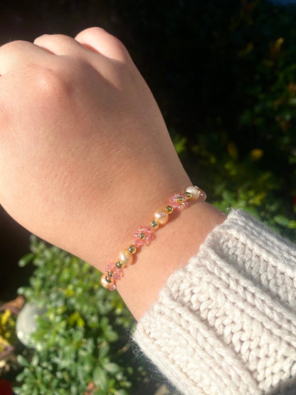 Pretty pink valentine flower crystal beaded bracelet with pink/orange pearls and 18k gold beads. Crystal flowers are a shiny pink. Perfect gift for all occasions; christmas, valentines, birthdays, mothers day