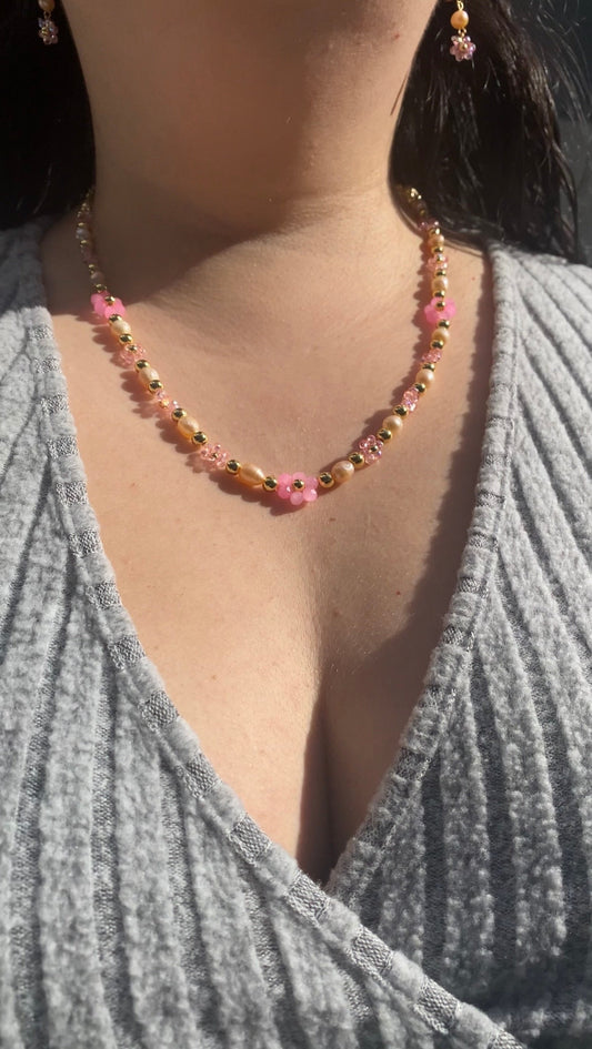 Handmade Pretty pink flower crystal beaded necklace with pink/orange freshwater pearls and 18k gold beads with a tarnish resistant gold brass chain. Crystal flowers in different sizes and different shades of pink. Perfect gift for any occasion!