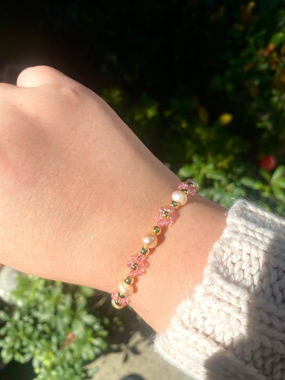 Pretty pink valentine flower crystal beaded bracelet with pink/orange pearls and 18k gold beads. Crystal flowers are a shiny pink. Perfect gift for all occasions; christmas, valentines, birthdays, mothers day