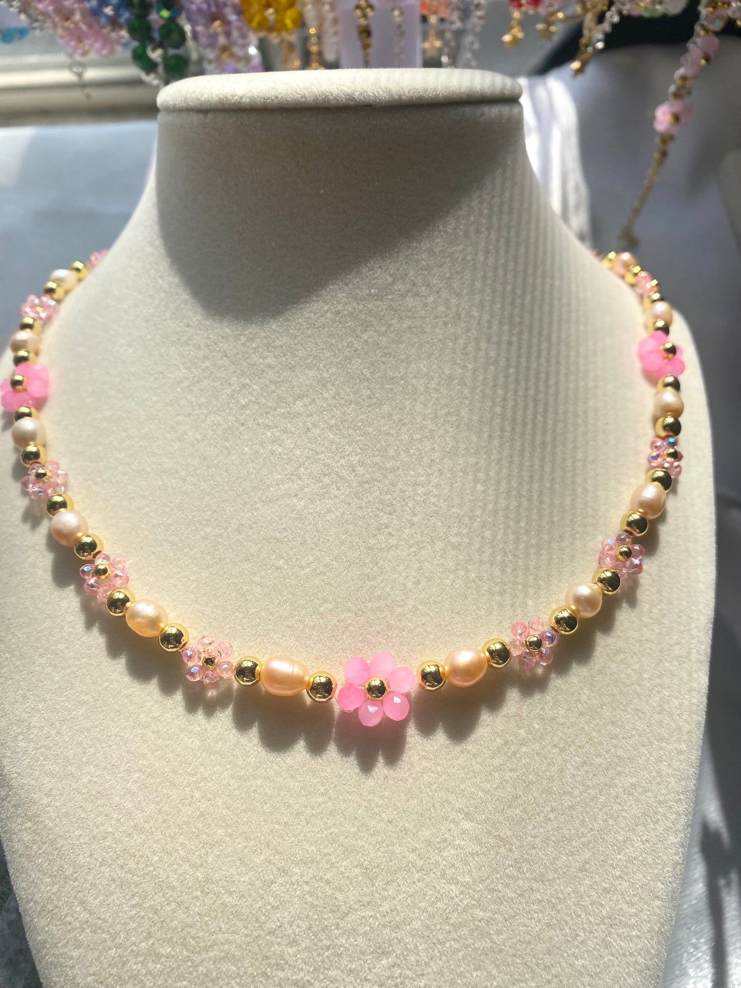 Handmade Pretty pink flower crystal beaded necklace with pink/orange freshwater pearls and 18k gold beads with a tarnish resistant gold brass chain. Crystal flowers in different sizes and different shades of pink. Perfect gift for any occasion!