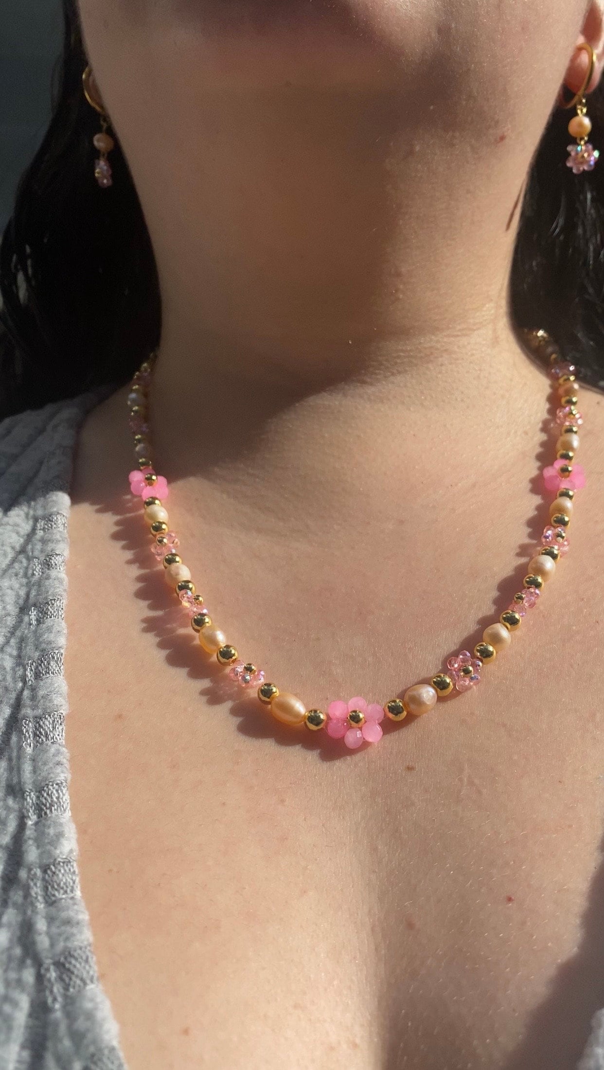 Handmade Pretty pink flower crystal beaded necklace with pink/orange freshwater pearls and 18k gold beads with a tarnish resistant gold brass chain. Crystal flowers in different sizes and different shades of pink. Perfect gift for any occasion!