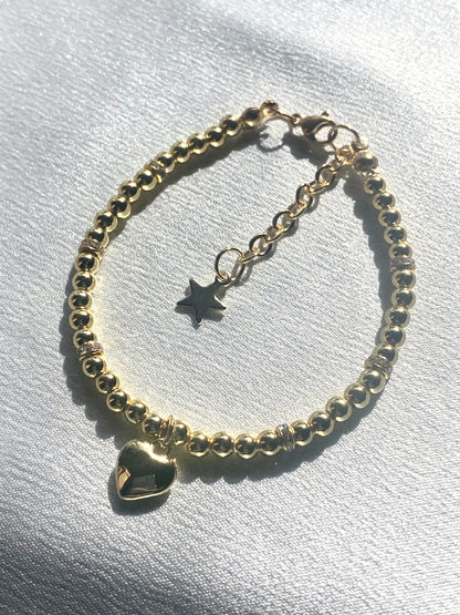 18k gold filled valentine heart beaded bracelet shown with an 18k gold plated heart pendant necklace with a stainless steel chain perfect gift for valentines day, date night, birthday, mothers day, or christmas. Handmade jewelry made to order.