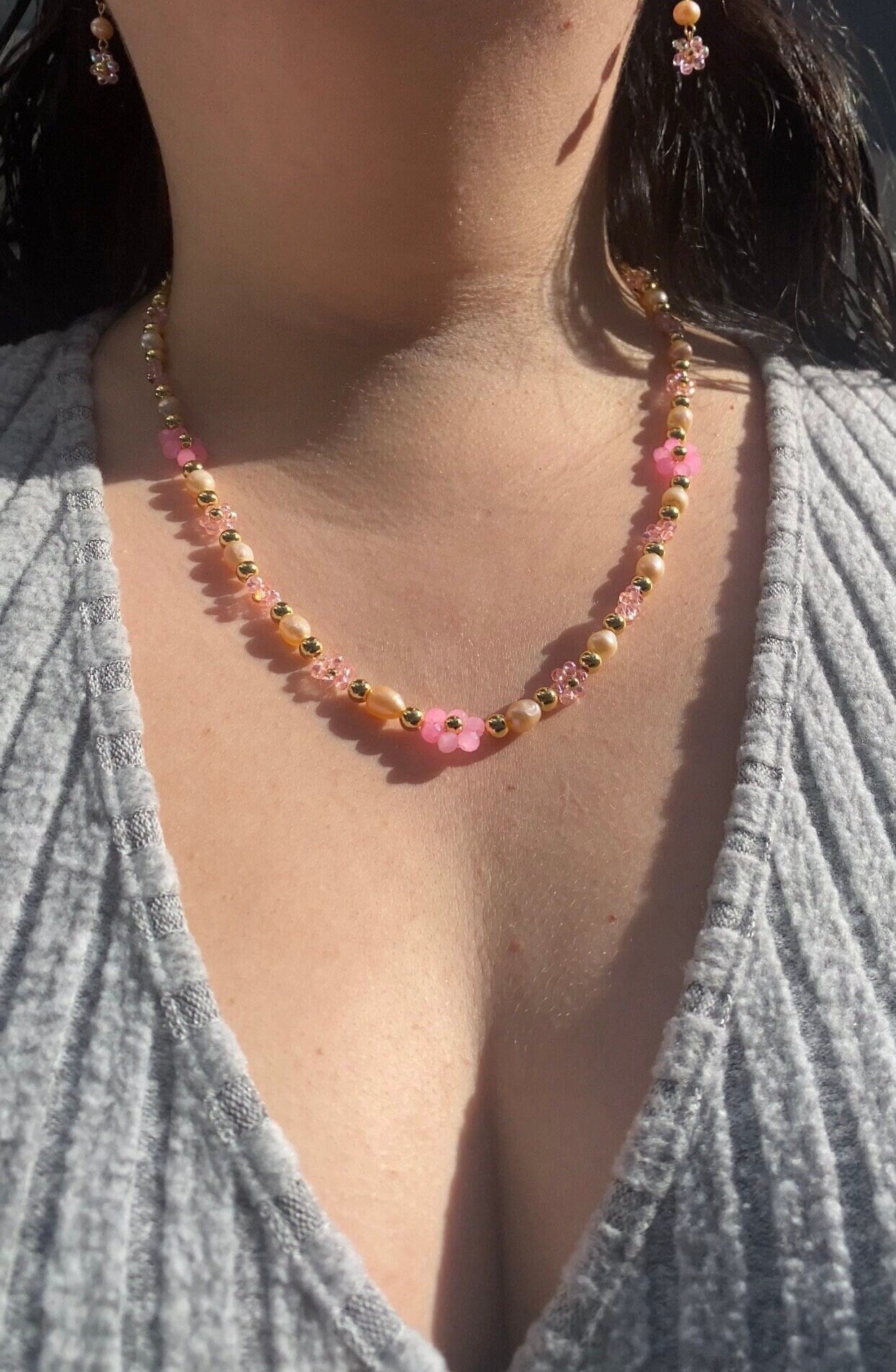 Handmade Pretty pink flower crystal beaded necklace with pink/orange freshwater pearls and 18k gold beads with a tarnish resistant gold brass chain. Crystal flowers in different sizes and different shades of pink. Perfect gift for any occasion!