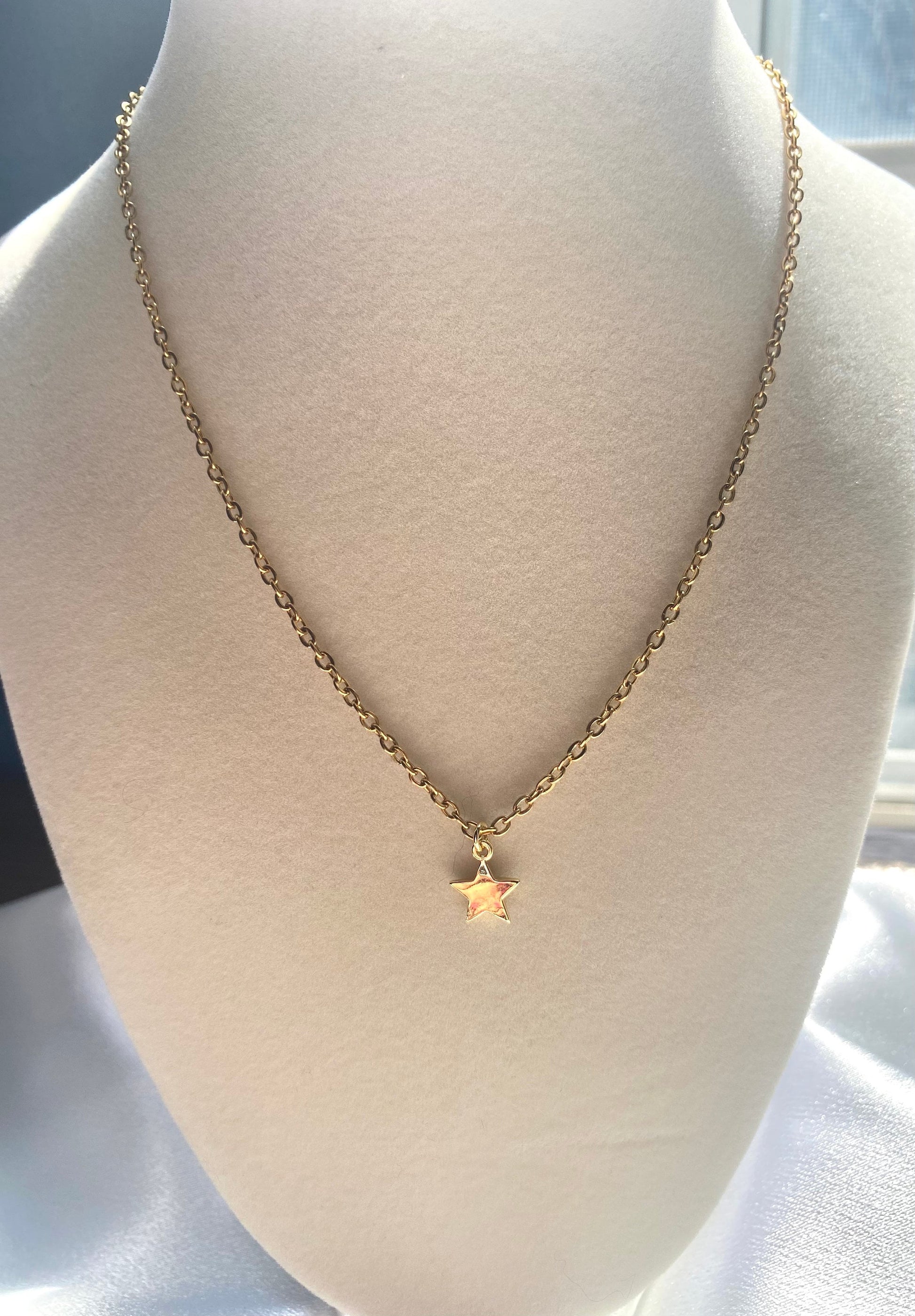 Showing an 18k Gold plated Star pendant necklace perfect gift for any friend or special person in your life. Perfect gift for a birthday or christmas or any holiday!