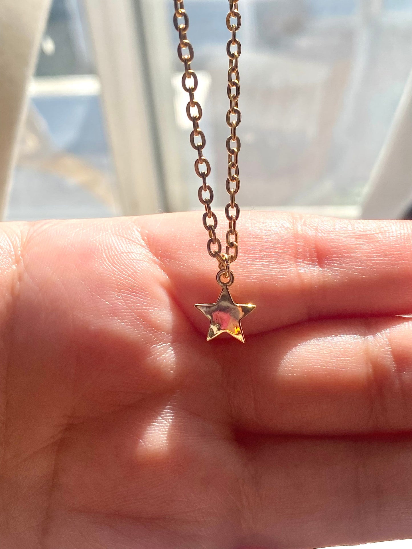 Showing an 18k Gold plated Star pendant necklace perfect gift for any friend or special person in your life. Perfect gift for a birthday or christmas or any holiday!