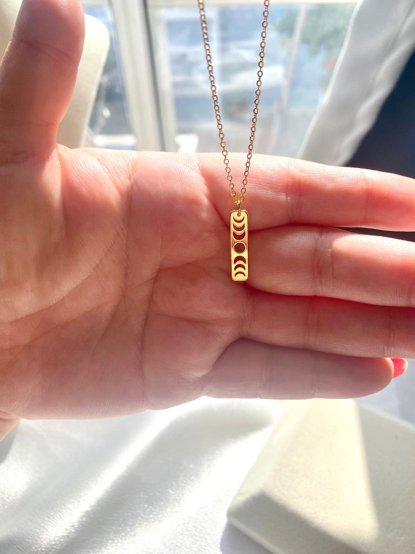 Showing an 18k Gold plated Moon phases pendant necklace available in gold and silver, perfect gift for any friend or special person in your life. Perfect gift for a birthday or christmas or any holiday!