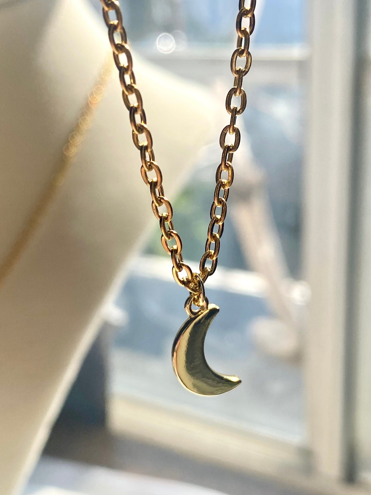 Showing an 18k Gold plated crescent moon pendant necklace perfect gift for any friend or special person in your life. Perfect gift for a birthday or christmas or any holiday!