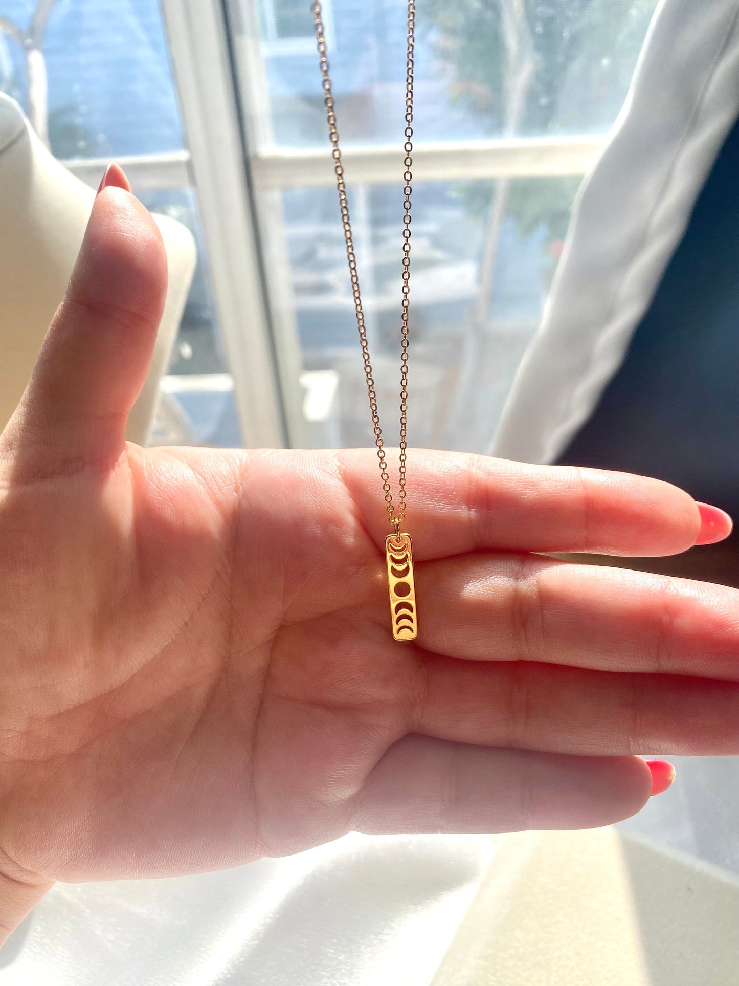 Showing an 18k Gold plated Moon phases pendant necklace available in gold and silver, perfect gift for any friend or special person in your life. Perfect gift for a birthday or christmas or any holiday!