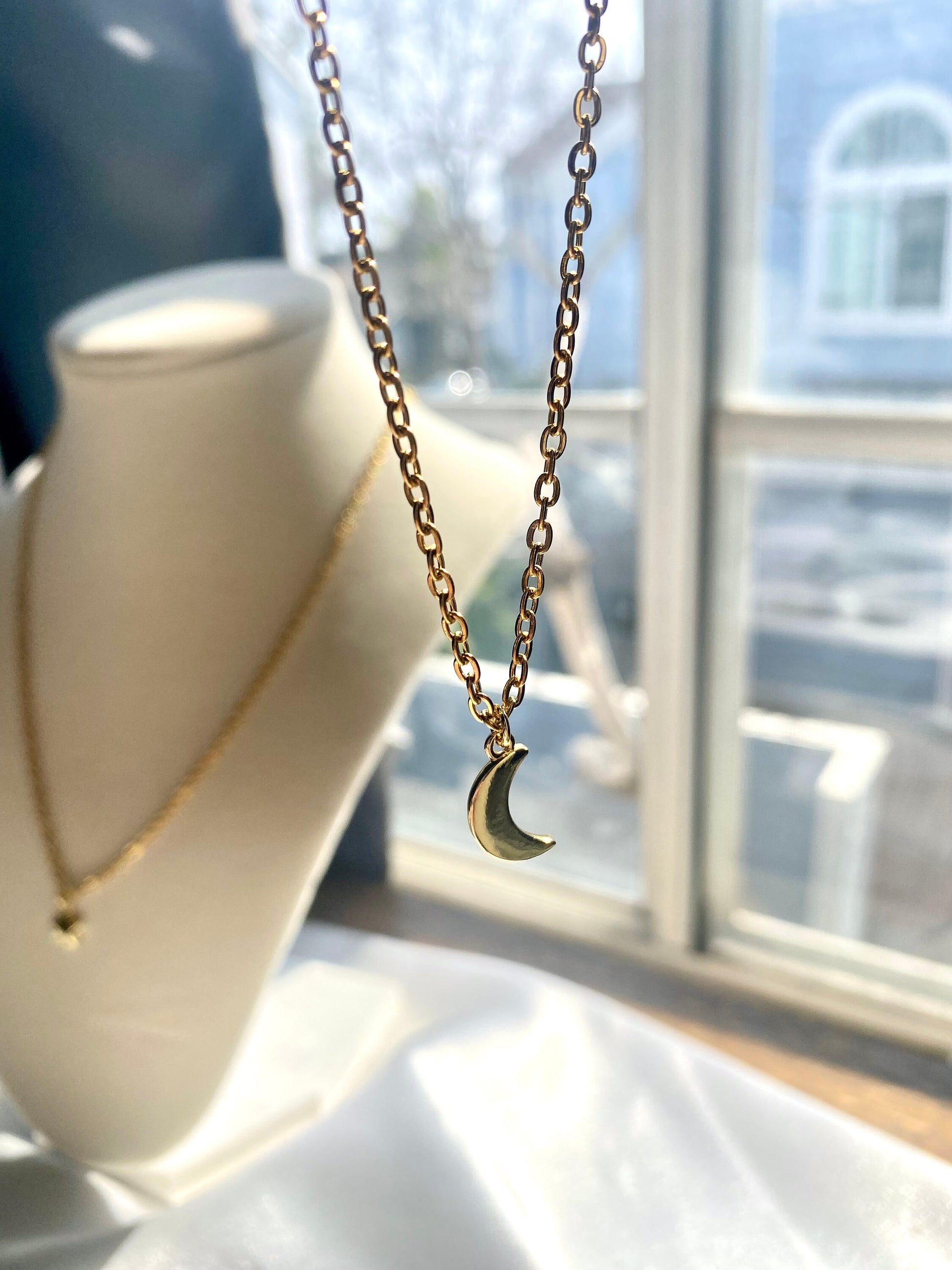 Showing an 18k Gold plated crescent moon pendant necklace perfect gift for any friend or special person in your life. Perfect gift for a birthday or christmas or any holiday!